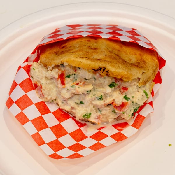 Venezuelan Chamo Cuisine's Reina Pepiada arepa, a golden corn cake filled with creamy chicken and avocado salad.