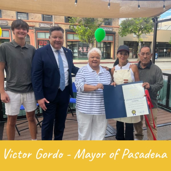 Victor Gordo, Mayor of Pasadena, with the owners of Chamo Venezuelan Cuisine and a young man.