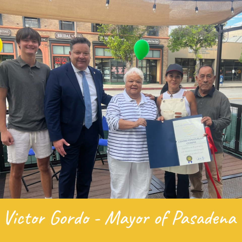 Victor Gordo, Mayor of Pasadena, with the owners of Chamo Venezuelan Cuisine and a young man.