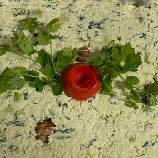 Venezuelan Chamo Cuisine's creamy chicken salad with cilantro and a tomato rose garnish.