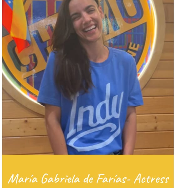 Venezuelan actress Maria Gabriela de Farias smiling in a blue t-shirt at Venezuelan Chamo Cuisine.